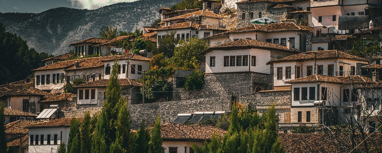 White houses with tiled roofs on a hillside in Berat, Albania