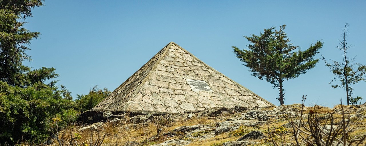 Stone pyramid monument on a rocky hillside in Burundi.