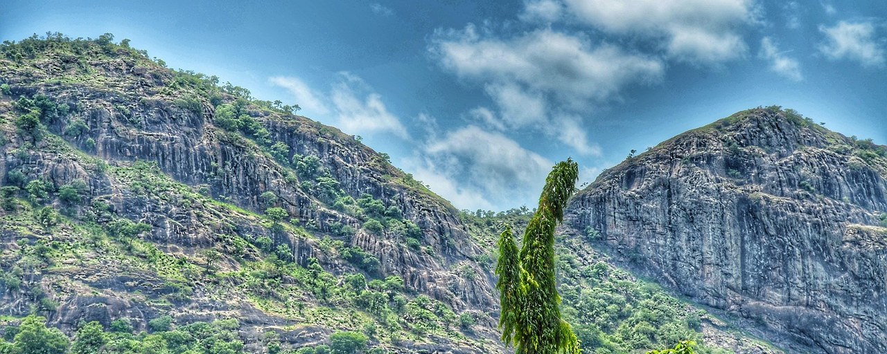 Rocky hills rising above lush vegetation in Benin.