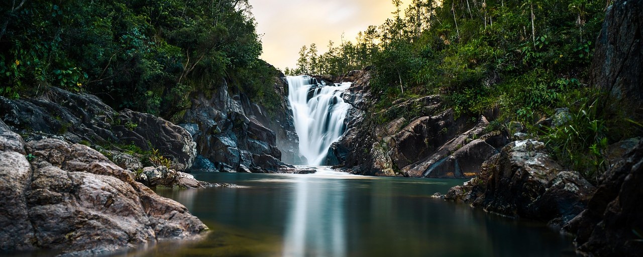Big Rock Falls flowing into a forest pool in Belize.