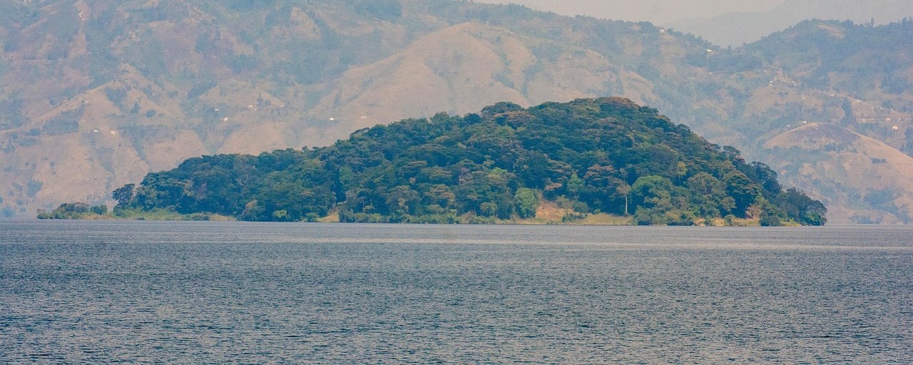 Wooded island and mountain shores on Lake Kivu in DR Congo.