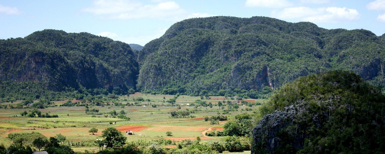Limestone hills and green farmland in Viñales Valley, Cuba.