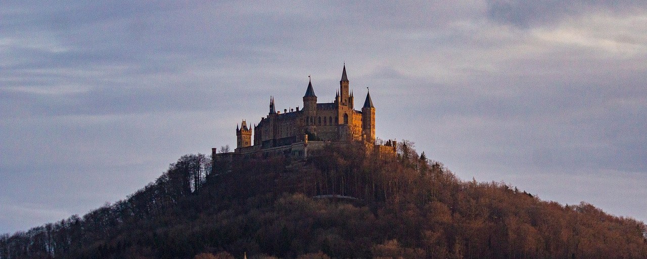Hohenzollern Castle above a wooded hill in Germany