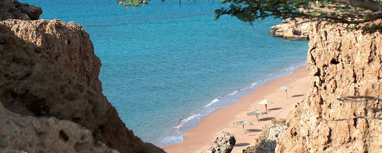 Ras Bir Beach framed by rocky cliffs in Djibouti
