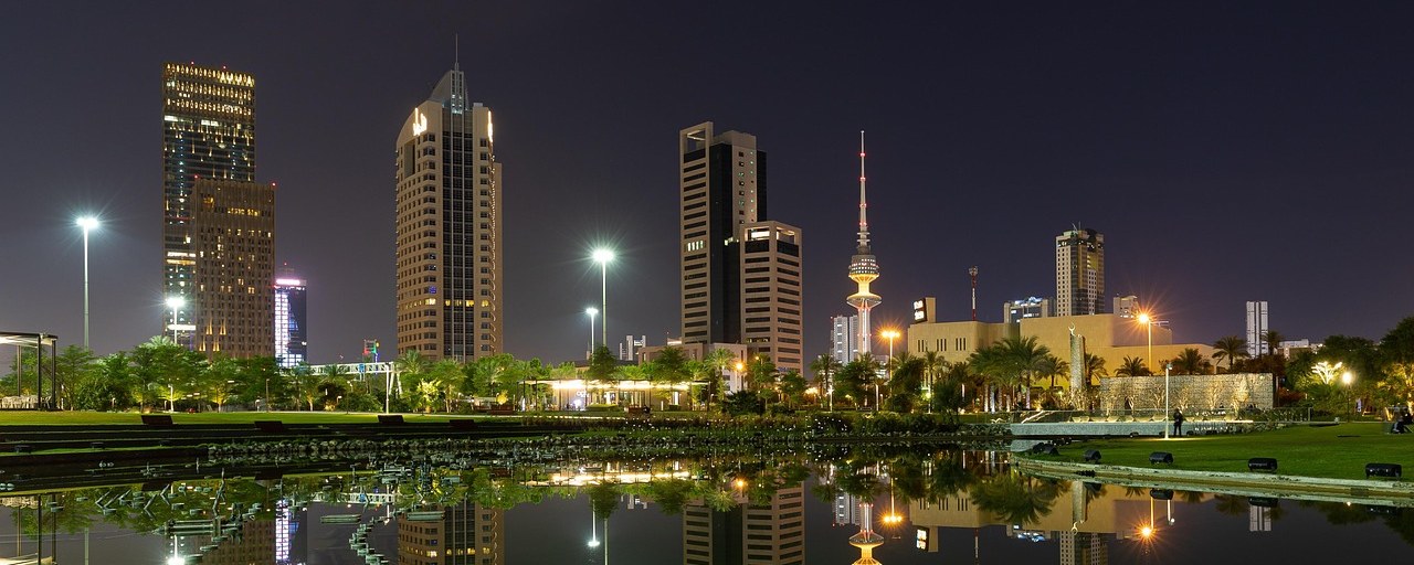Kuwait City skyline reflected in a pond at night, Kuwait