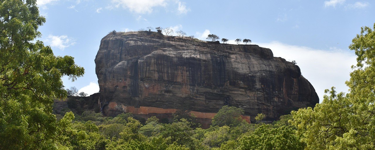 Sigiriya Lion Rock rising above tropical forest in Sri Lanka.