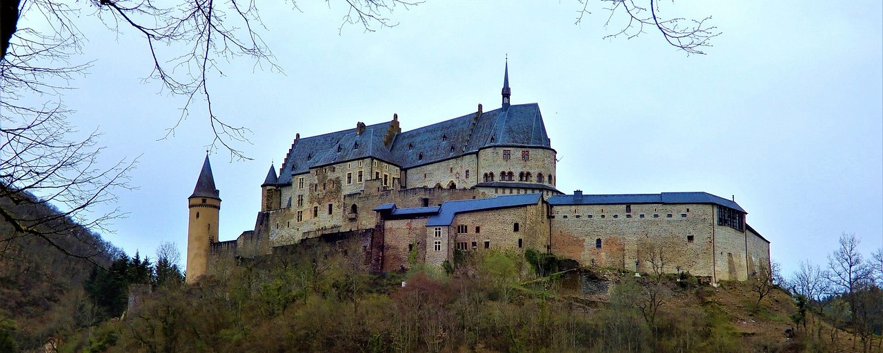 Vianden Castle above a wooded hillside in Luxembourg