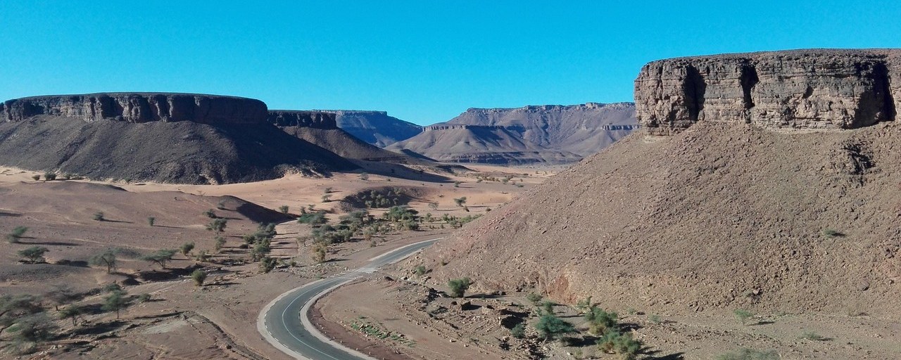 Winding desert road between rocky plateaus in Mauritania