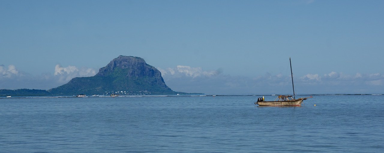 Le Morne mountain and a sailboat on the lagoon, Mauritius