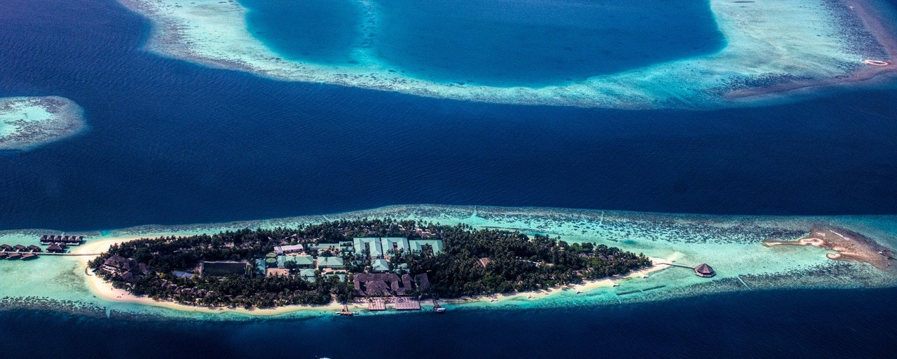 Island and turquoise coral atolls in the Maldives