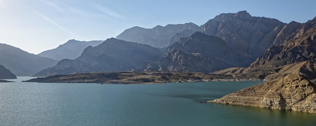 Wadi Dayqah reservoir surrounded by rocky mountains in Oman