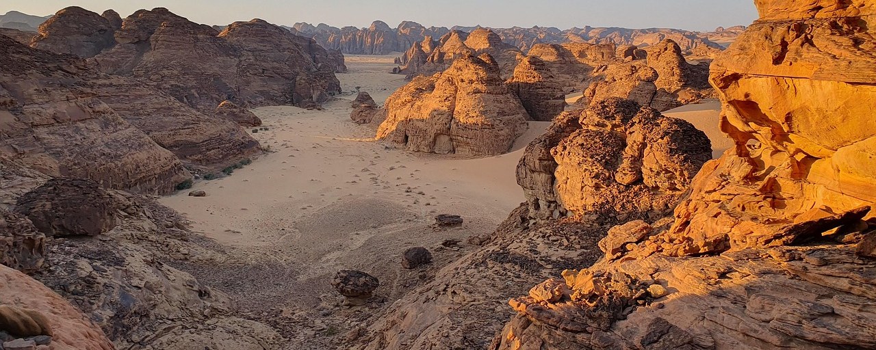 Sunlit desert rock formations in Saudi Arabia