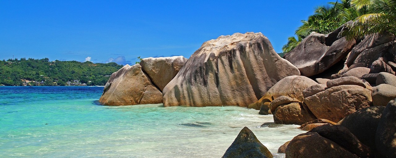 Granite boulders and turquoise water along the Seychelles coastline
