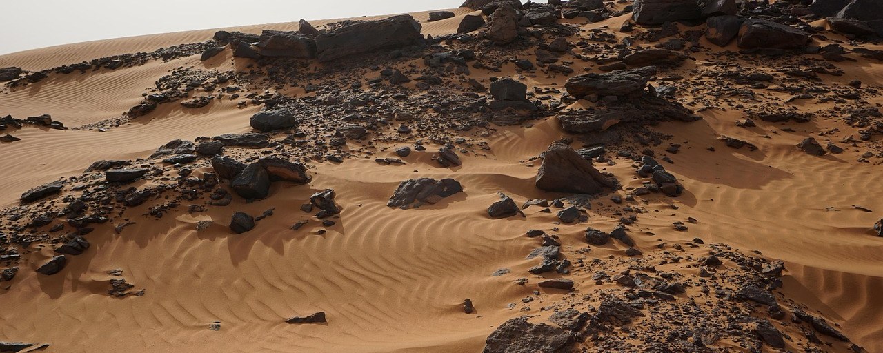 Sand dunes and rocky outcrops near Meroë, Sudan.