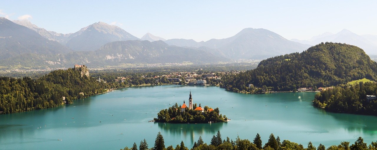 Lake Bled and its island church beneath mountains in Slovenia