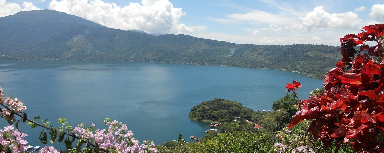 Lake Coatepeque surrounded by mountains and flowers in El Salvador
