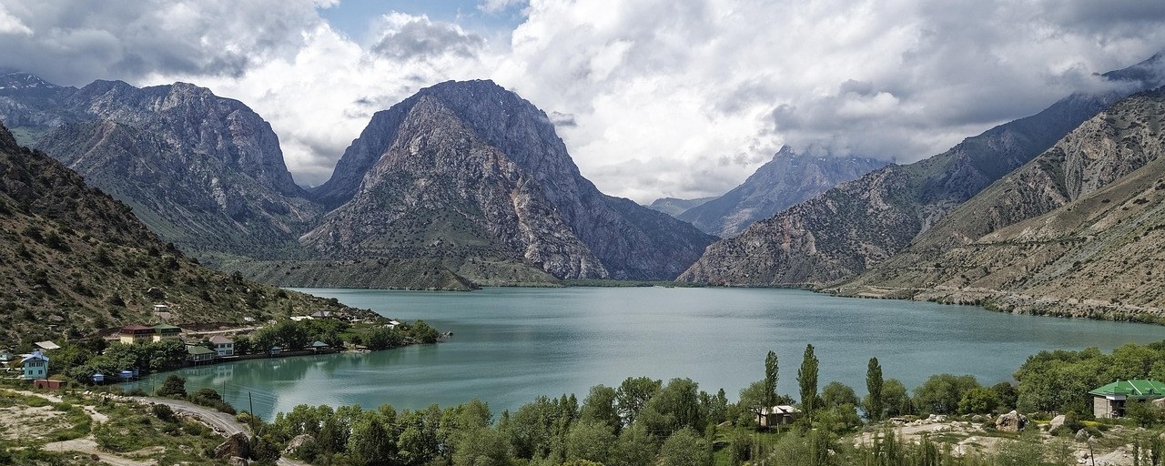 Iskanderkul lake surrounded by rugged mountains in Tajikistan.