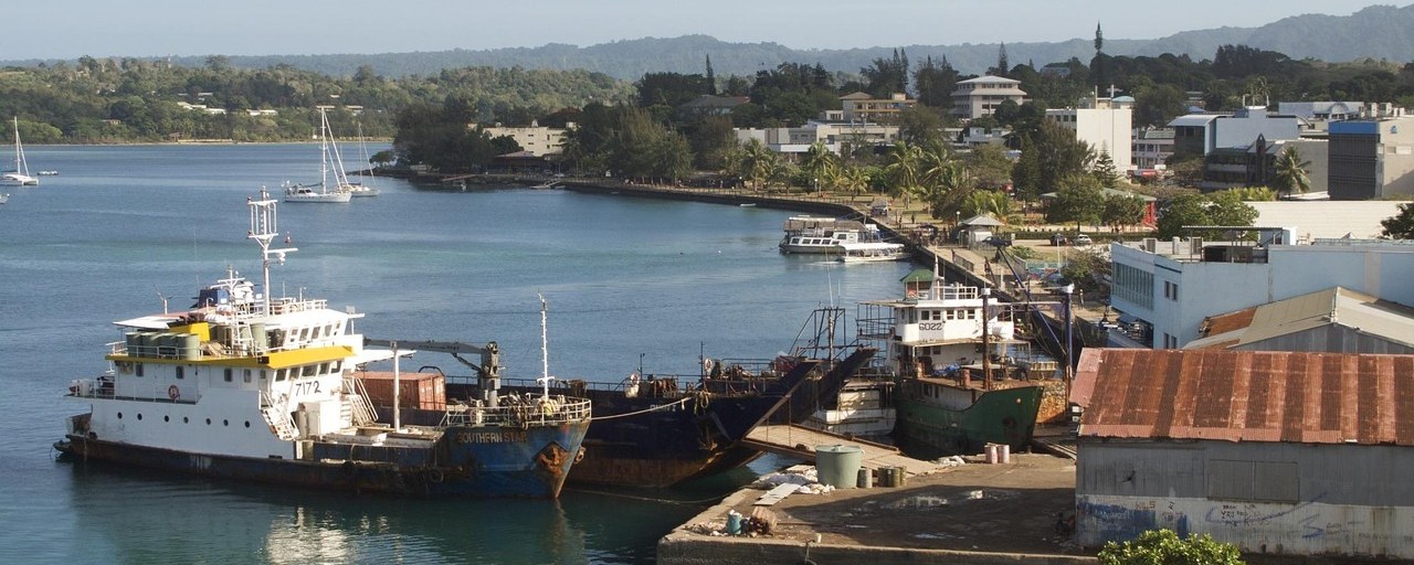 Boats and waterfront buildings at a harbor in Vanuatu